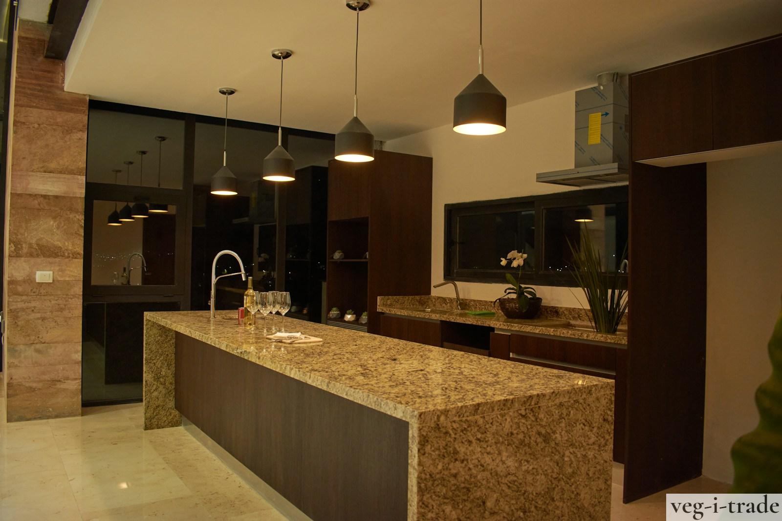 a large kitchen with a marble counter top