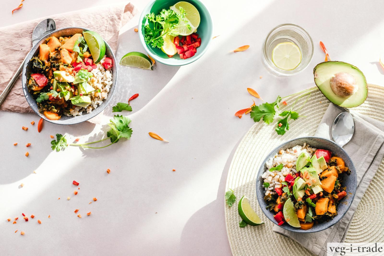 Top-down view of vibrant vegan bowls filled with fresh vegetables, perfect for a healthy meal.
